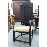 A mid 19thC Continental stained oak and fruitwood framed hall chair with a high panelled back,
