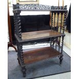 A late Victorian rosewood three tier what-not with barleytwist supports,