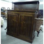 A mid Victorian rosewood chiffonier with a panelled upstand, over two panelled doors,