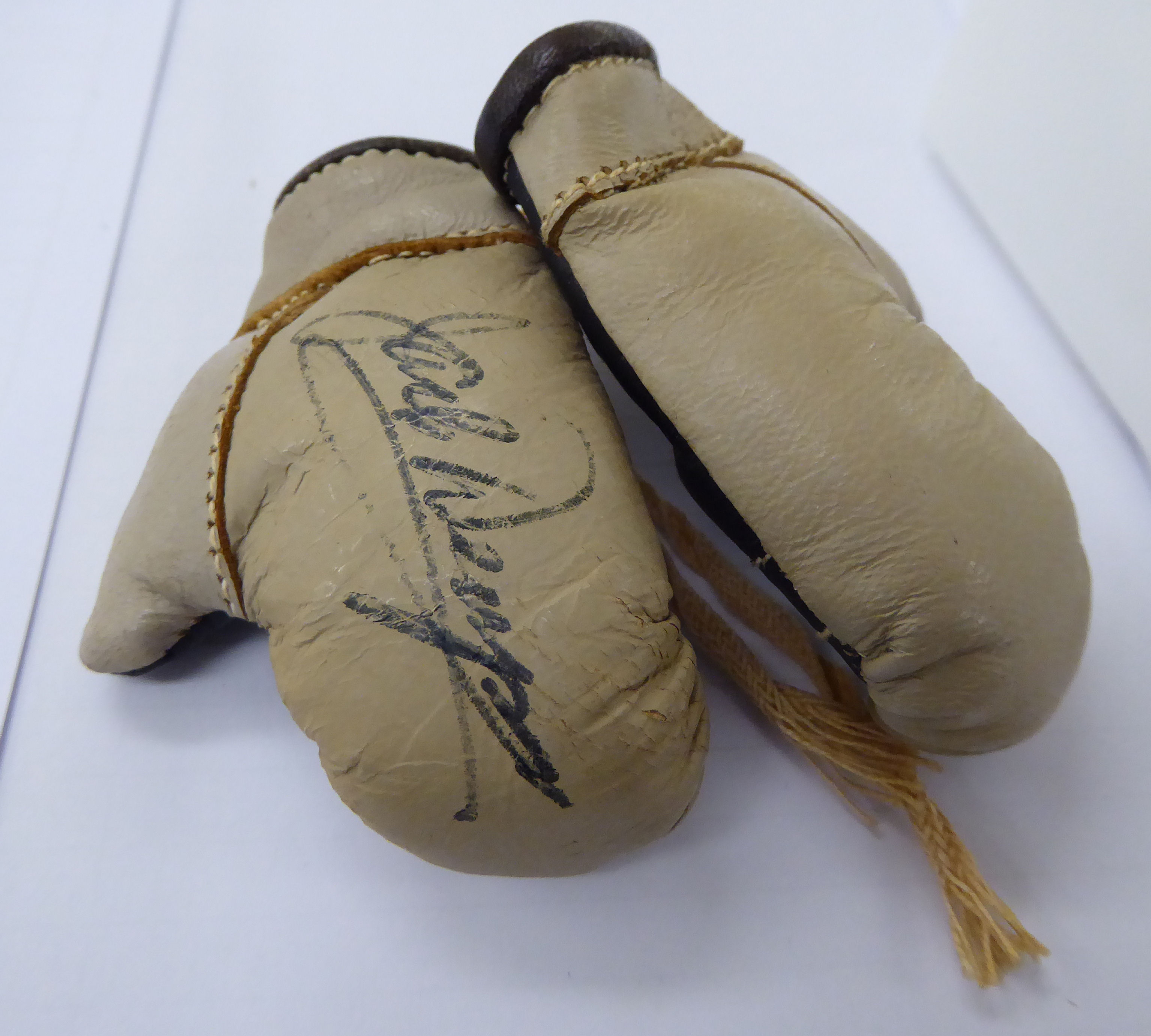 A pair of miniature two-tone brown leather boxing gloves,