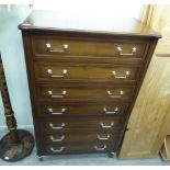 A modern mahogany finished tall boy, the seven graduated long drawers with bail handles,