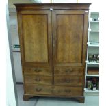 A late Victorian mahogany linen press with two panelled doors and a long drawer,