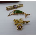 Three similar 9ct gold brooches: to include a swordfish,
