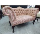 A Stuart Jones window seat of miniature traditional settee design with a low back and scrolled arms,