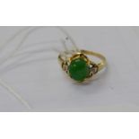 An 18ct gold ring, set with a jade stone,