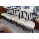 A set of six early 20thC Sheraton inspired mahogany framed dining chairs with carved,