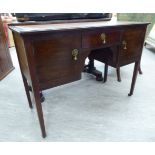 A 1930s mahogany kneehole writing table, set with a tooled hide scriber,