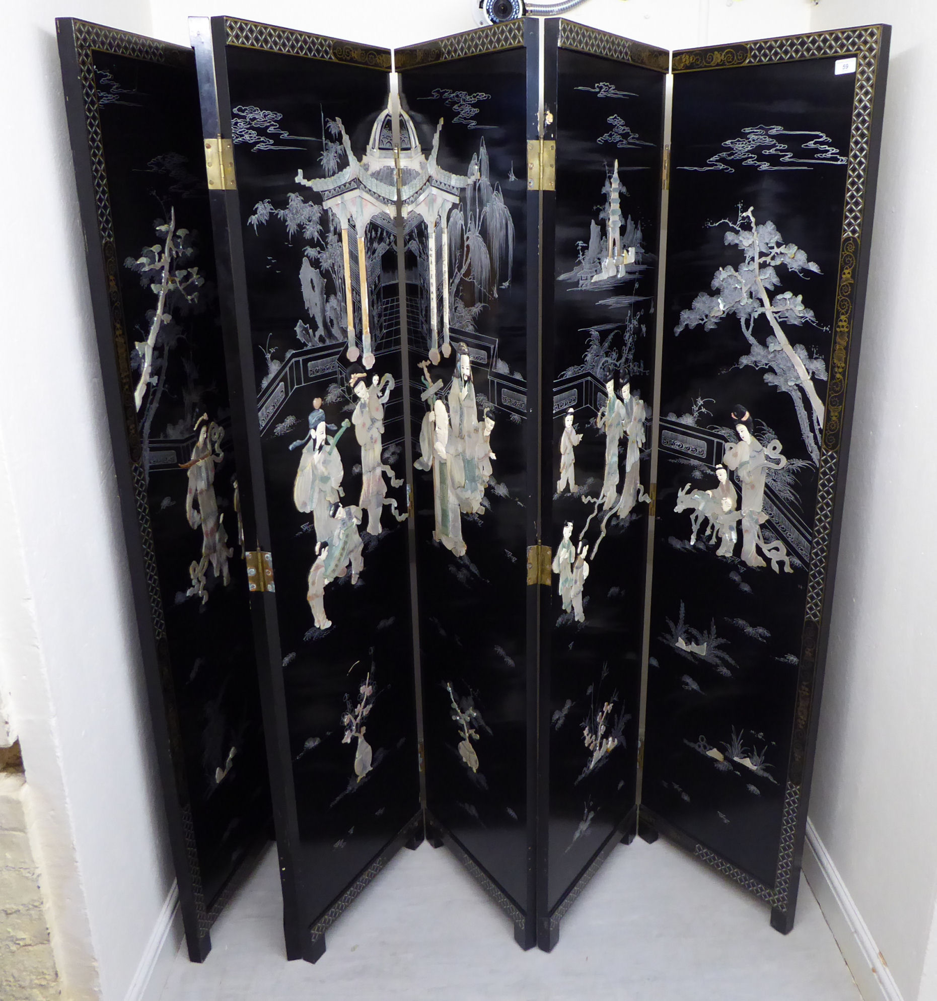A 20thC Chinese black lacquered six panelled room screen, decorated with flora and text,