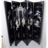 A 20thC Chinese black lacquered six panelled room screen, decorated with flora and text,