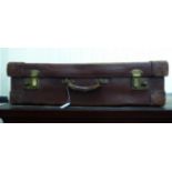 A 1930/40s moulded and stitched brown hide suitcase with corner reinforcement,
