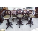 A set of three early/mid 20thC mahogany framed high bar stools with carved and lath backs,