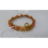 A gold coloured metal multi-ribbon design bracelet,