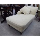 A Peter Knight daybed of traditional design with a scrolled end,