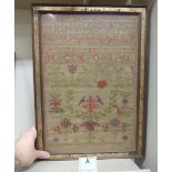 An early Victorian sampler, featuring letters of the alphabet, stylised birds,