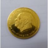A commemorative Churchill gold coin 11