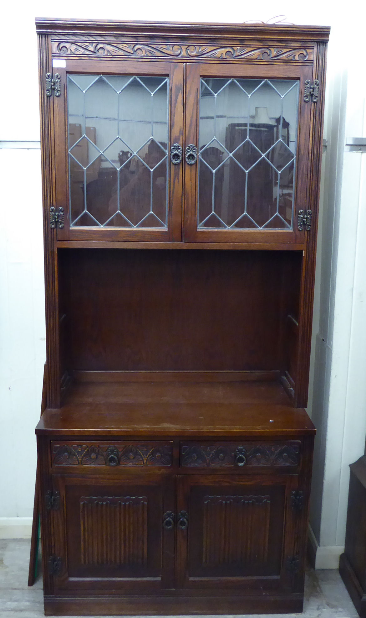 An Old Charm stained and carved oak display cabinet,