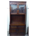 An Old Charm stained and carved oak display cabinet,