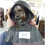 An early 20thC cast and patinated bronze bust,