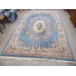 A Chinese washed woollen rug with floral designs on a blue ground 105'' x 125'' CA