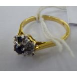 An 18ct gold diamond and sapphire cluster ring 11