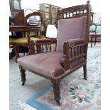 A late Victorian mahogany framed salon chair, upholstered in a pink fabric,