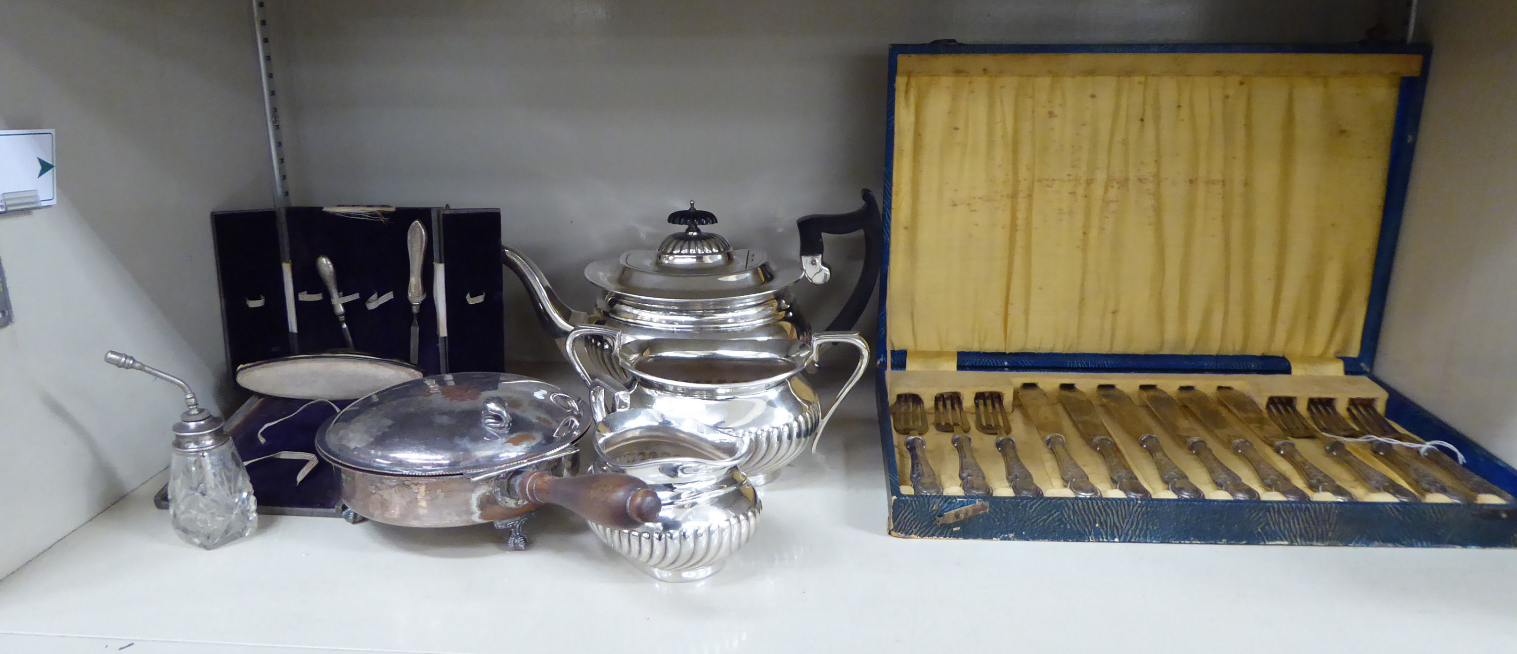 A set of six silver plated fish knives and forks cased; a silver plated breakfast dish 6''dia;