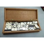 A set of bone and ebony dominos, in a teak case 2.