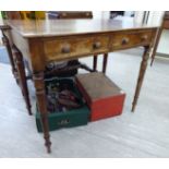 A late Victorian mahogany two drawer side table, raised on ring turned,