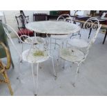 A modern Victorian style white painted metal patio table 30''h 36''dia;