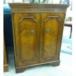 A modern mahogany finished hi-fi cabinet with two doors,