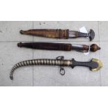 Three similar Indian daggers,