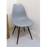 A Vitra Eames design grey plastic tub design chair,