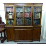 A modern mahogany finished breakfront livingroom unit with four astragal glazed doors,