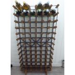 A seventy-two division pine and aluminium framed wine rack 54''h 24''w CB