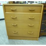 A 1960s/70s oak four drawer dressing chest, the upper drawer fitted with a folding mirror,