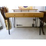 A modern light oak desk with an open shelf galleried superstructure, over two in-line drawers,
