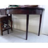 An early 19thC mahogany demi-lune hall table, raised on square,