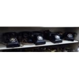 Nine 'vintage' black plastic cased cradle telephones with rotating dials OS8