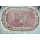 Three Chinese washed woollen rugs: to include an example with floral designs on a peach ground