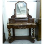 A late Victorian mahogany Duchess design dressing table with a mirrored back and four short drawers,