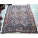 A Persian rug with two columns of three diamond shaped motifs,