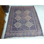 A Persian rug with two columns of three diamond shaped motifs,