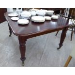 A late Victorian draw leaf dining table, the top with rounded corners, raised on octagonal,