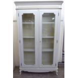 A Laura Ashley cream painted armoire with a moulded and fluted cornice,