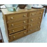 A modern pine dressing chest with two banks of four drawers,