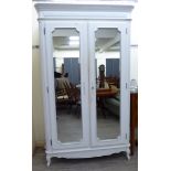 A Laura Ashley white painted armoire with a moulded, fluted cornice,