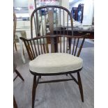 An Ercol stained beech and elm framed Windsor high hoop back arm chair,