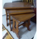 A nesting set of three Ercol elm occasional tables,