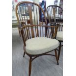 An Ercol stained beech and elm framed Windsor high hoop back arm chair,