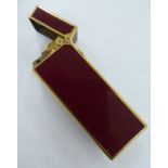 A Dunhill yellow metal plated and enamelled, burgundy coloured, box design,